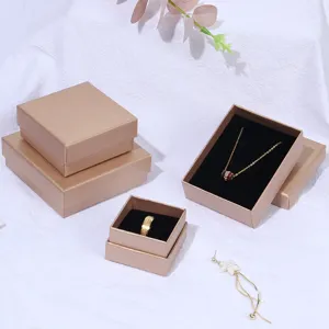 Detailed view of various sizes of champagne gold jewelry gift boxes with black inserts