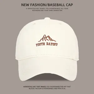Close-up detail of the off-white baseball cap with embroidered mountain logo and text.