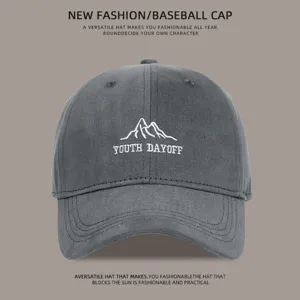 Close-up detail of the dark gray washed cotton baseball cap with embroidered mountain logo.