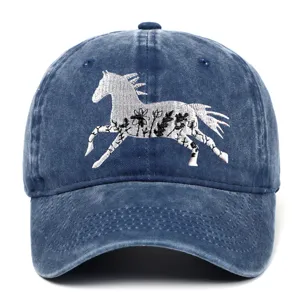 Washed cotton baseball cap featuring detailed white floral horse embroidery on blue denim