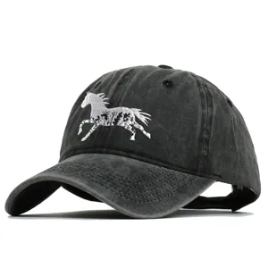 Macro detail of intricate white horse floral embroidery on black washed cotton baseball cap