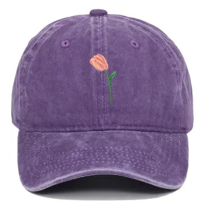 Détail d'une broderie de tulipe rose sur une casquette de baseball vintage violette