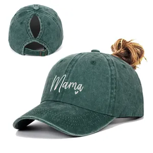 Close-up of Mama embroidery and ponytail hole design on dark green washed baseball cap