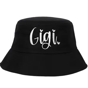 Detailed close-up of white Gigi embroidery on a black cotton bucket hat.