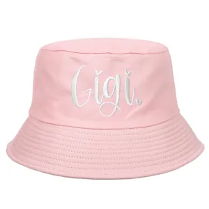 Detail of white Gigi script embroidery on a soft pink cotton bucket hat