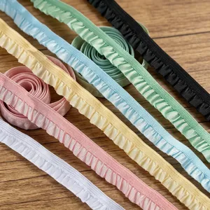 Close-up of colorful elastic ruffled lace trim, pleated ribbon details for DIY sewing crafts.