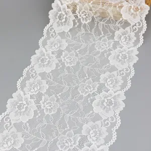 White elastic lace trim fabric detail shot with floral pattern for DIY sewing crafts.