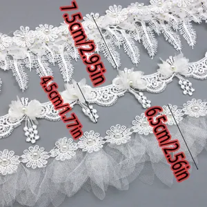 Close-up details of white water-soluble lace trim with pearls, showing various widths for sewing.