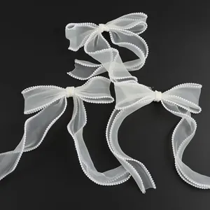 White organza bows with pearl trim, ideal for wedding decor, gift wrapping and DIY crafts.