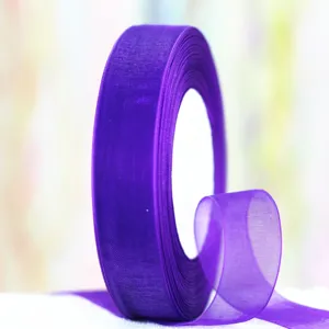 Close-up detail of a vibrant purple chiffon ribbon roll, lightweight sheer fabric trim for crafts.