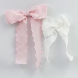 Fabric bow ribbon detail shot showing crinkled texture and wavy edge design for gifts and hair decor.