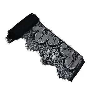 Close-up detail of black eyelash lace trim, delicate floral embroidery for DIY craft projects.