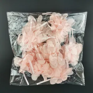 Close-up of pink chiffon flower petals with ribbons, perfect for handmade DIY crafts and gifts.
