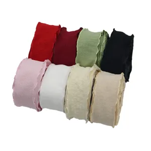 Ruffled pleated ribbon close-up, wavy edge design, perfect for gift wrapping and hair accessories.