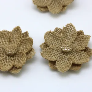 Close-up detail of 6cm handmade burlap jute flowers, rustic craft fabric floral decor for DIY.