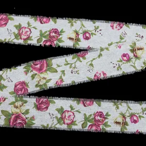 Detailed view of 5cm wide linen fabric ribbon with vintage rose floral print and frayed edges.