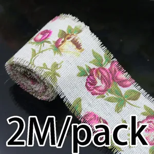 Close-up detail of 5cm width linen ribbon roll with pink vintage rose floral print for sewing.