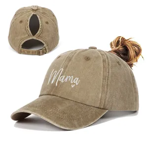 Close-up of Mama heart embroidery and ponytail hole on washed cotton baseball cap