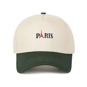 Nahaufnahme der retro PARIS Stickerei auf einer beigefarbenen und waldgrünen Baseballkappe