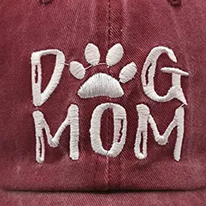 Detailed view of white DOG MOM embroidery on a burgundy washed cotton baseball cap
