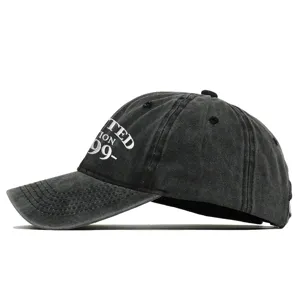 Side profile detail showing the white 1999 embroidery on a washed black cotton baseball cap