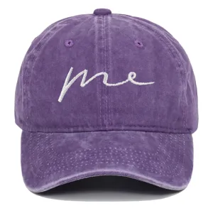 Detail of purple washed cotton baseball cap with embroidered cursive me text