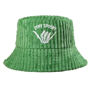 Detail of green corduroy bucket hat featuring white Stay Spooky skeleton hand embroidery