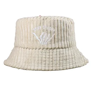 Close-up of a beige corduroy bucket hat featuring STAY SPOOKY skeleton hand embroidery