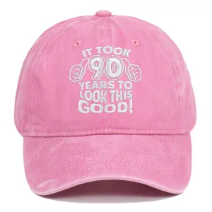Detailed view of pink washed cotton cap with 90th birthday white embroidered slogan
