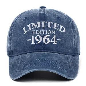 Close-up of washed denim baseball cap with white 1964 limited edition embroidery.