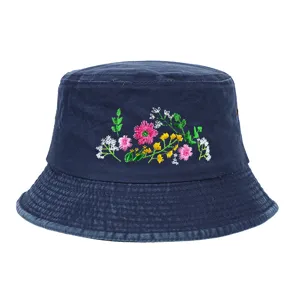 Detail shot of a navy washed bucket hat with colorful wildflower embroidery