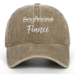 Close-up view of vintage washed khaki cap featuring white Fiancé embroidery detail