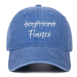 Detailed front view of a vintage blue washed baseball cap with white Fiancé embroidery