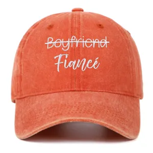Close-up detail of Fiancé white embroidery on a washed vintage coral baseball cap