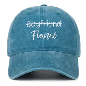Close-up of 'Boyfriend Fiance' white embroidery on vintage washed blue denim baseball cap