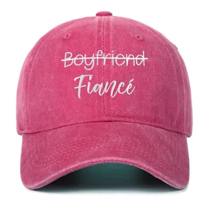 Macro shot of high-quality white embroidery text on pink washed cotton fabric cap