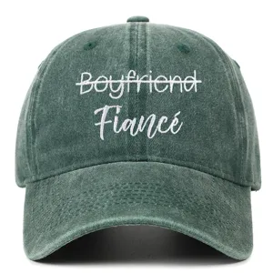Close-up of Fiance and crossed-out Boyfriend embroidery on washed green baseball cap.
