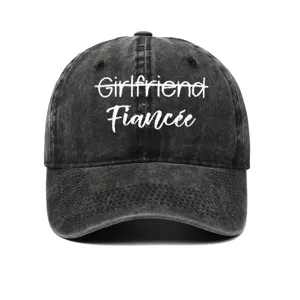 Close-up of vintage washed black cotton baseball cap with white Fiancée embroidery