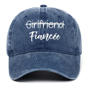 Close-up of white Fiancée embroidery on a vintage washed blue denim baseball cap