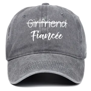 Detail view of washed gray baseball cap with white Fiancée embroidery