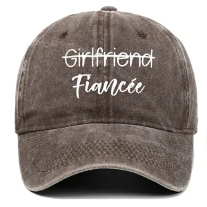 Detailed view of white Fiancée embroidery on a brown washed cotton vintage baseball cap