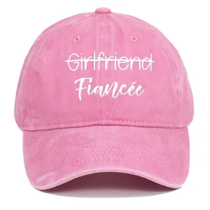 Close-up of pink washed baseball cap with white Fiancée embroidery detail