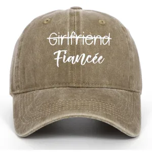 Close-up of embroidered Fiancée text on a washed vintage khaki baseball cap