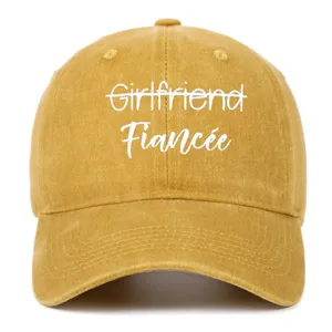Front view of washed yellow baseball cap with Fiancée white embroidery