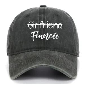 Close-up of white "Fiancée" embroidery on a vintage washed charcoal grey baseball cap.