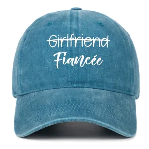 Detail of a vintage washed blue denim baseball cap with white Fiancée embroidery
