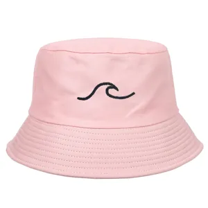 Detailed view of pink bucket hat featuring a black embroidered wave design.