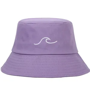 Detail view of purple bucket hat featuring a white wave embroidery pattern on canvas
