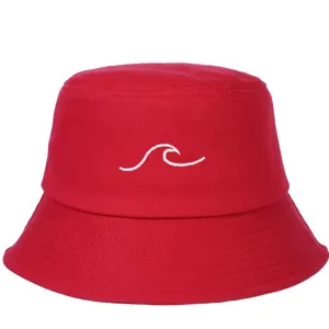 Detailed view of a vibrant red bucket hat featuring a white minimalist wave embroidery.