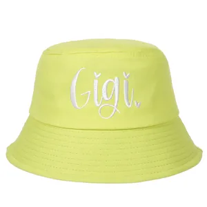 Vibrant lime green cotton bucket hat featuring white cursive Gigi letter embroidery